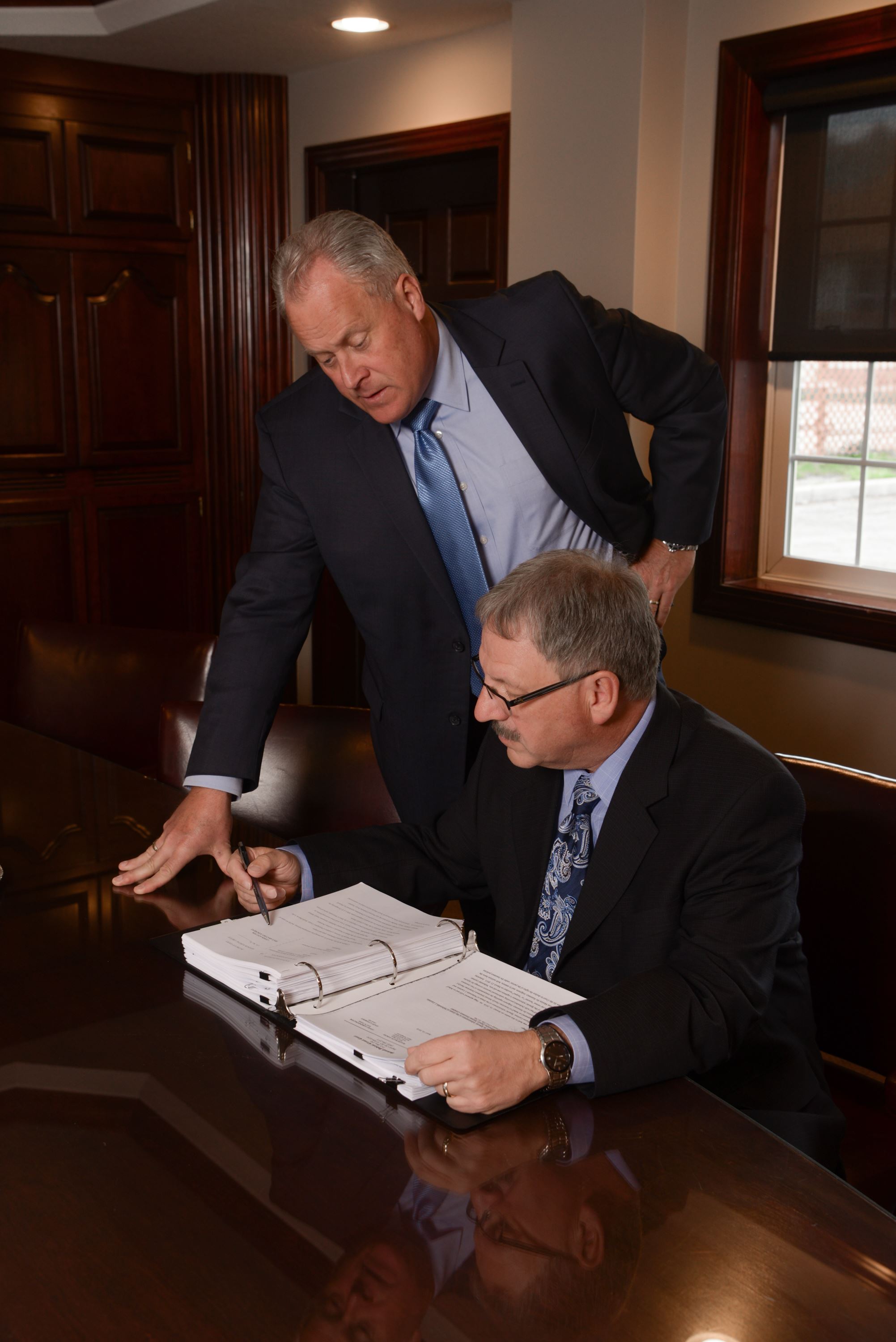 Rexford Hagg and John Dorsey reviewing a case